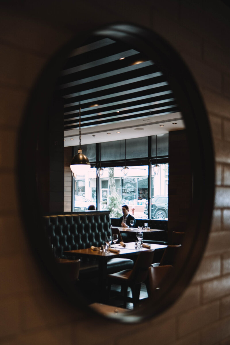 View of patron sitting at bench seating